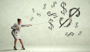 Image of attractive businesswoman pulling rope with dollar symbol
